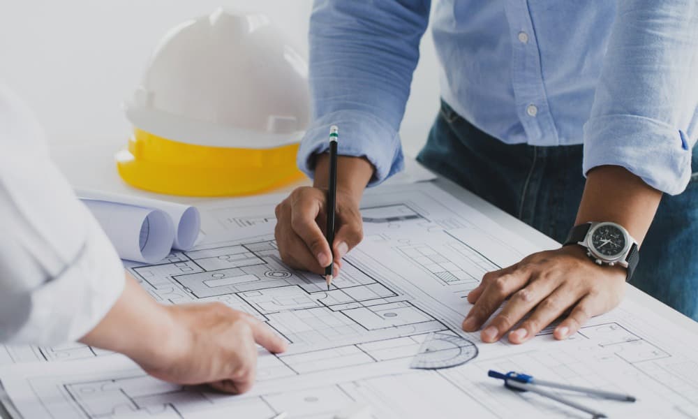 Engineers collaborating during the design phase of a commercial construction project.