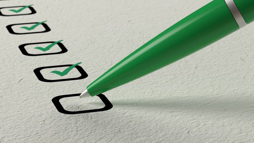 A green pen checking off boxes in green ink.